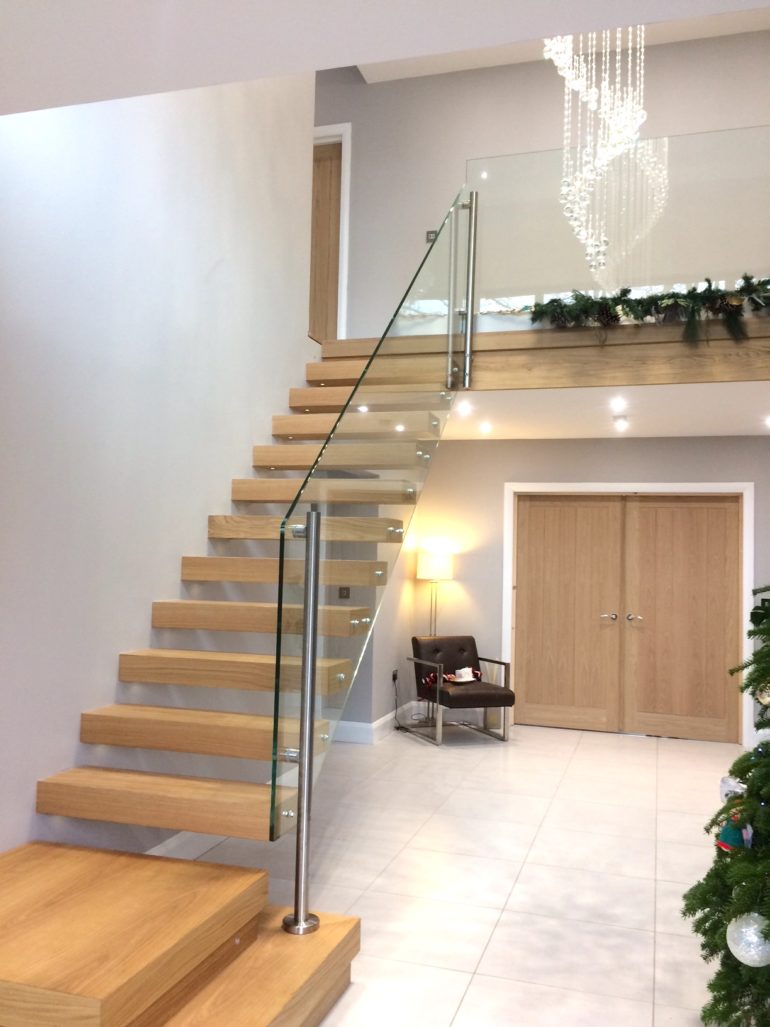 entry hall staircase decorated in Christmas decorations