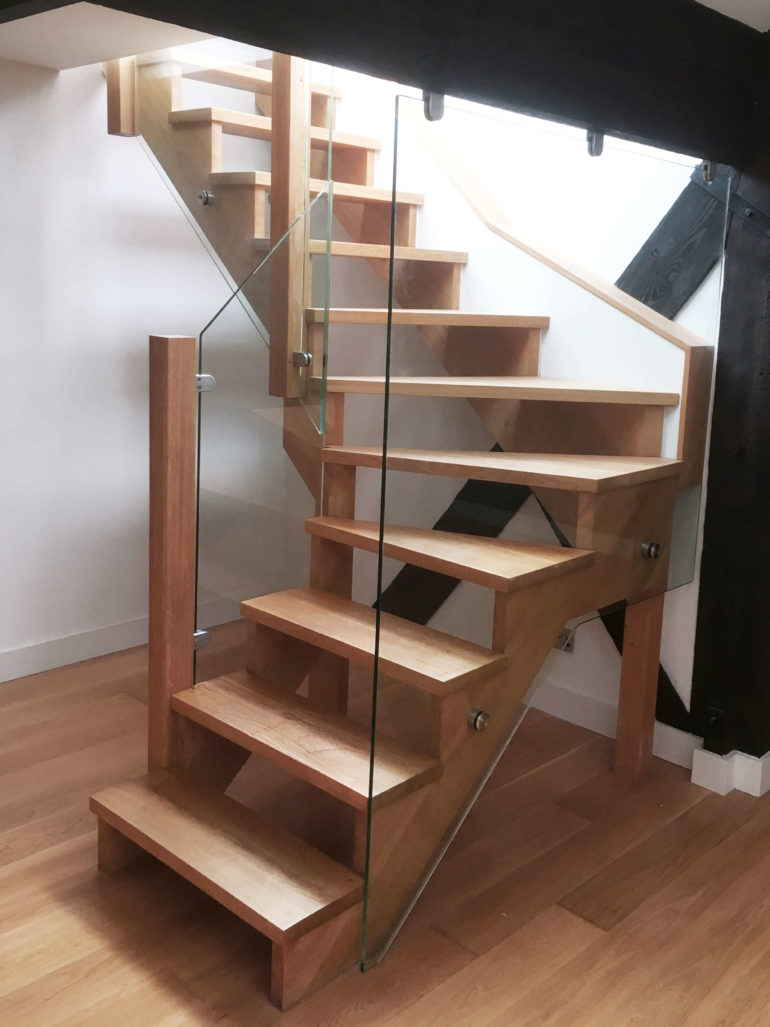 open floating staircase with glass bannisters