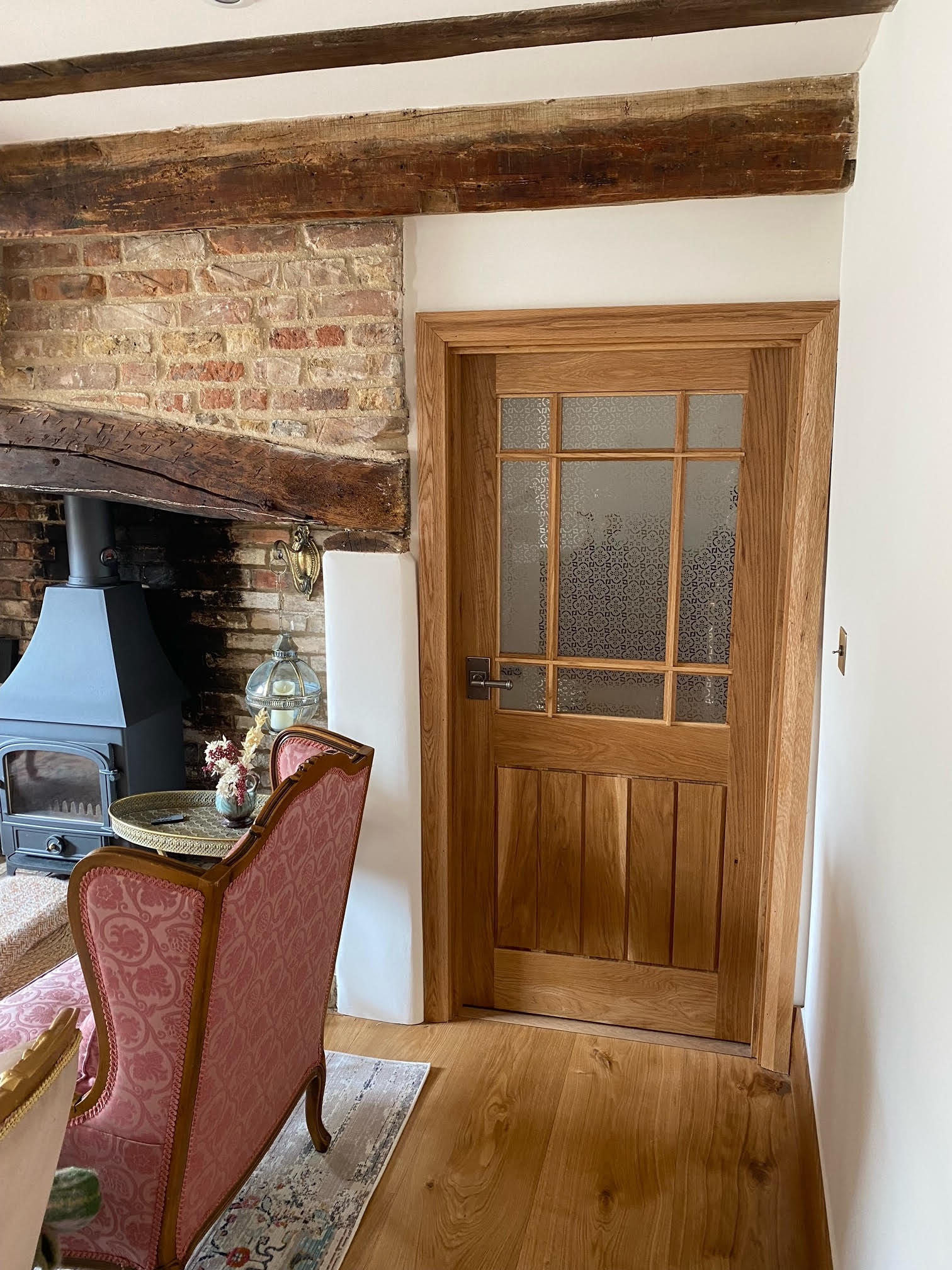 glass panels in bespoke wooden internal door of cottage an living room