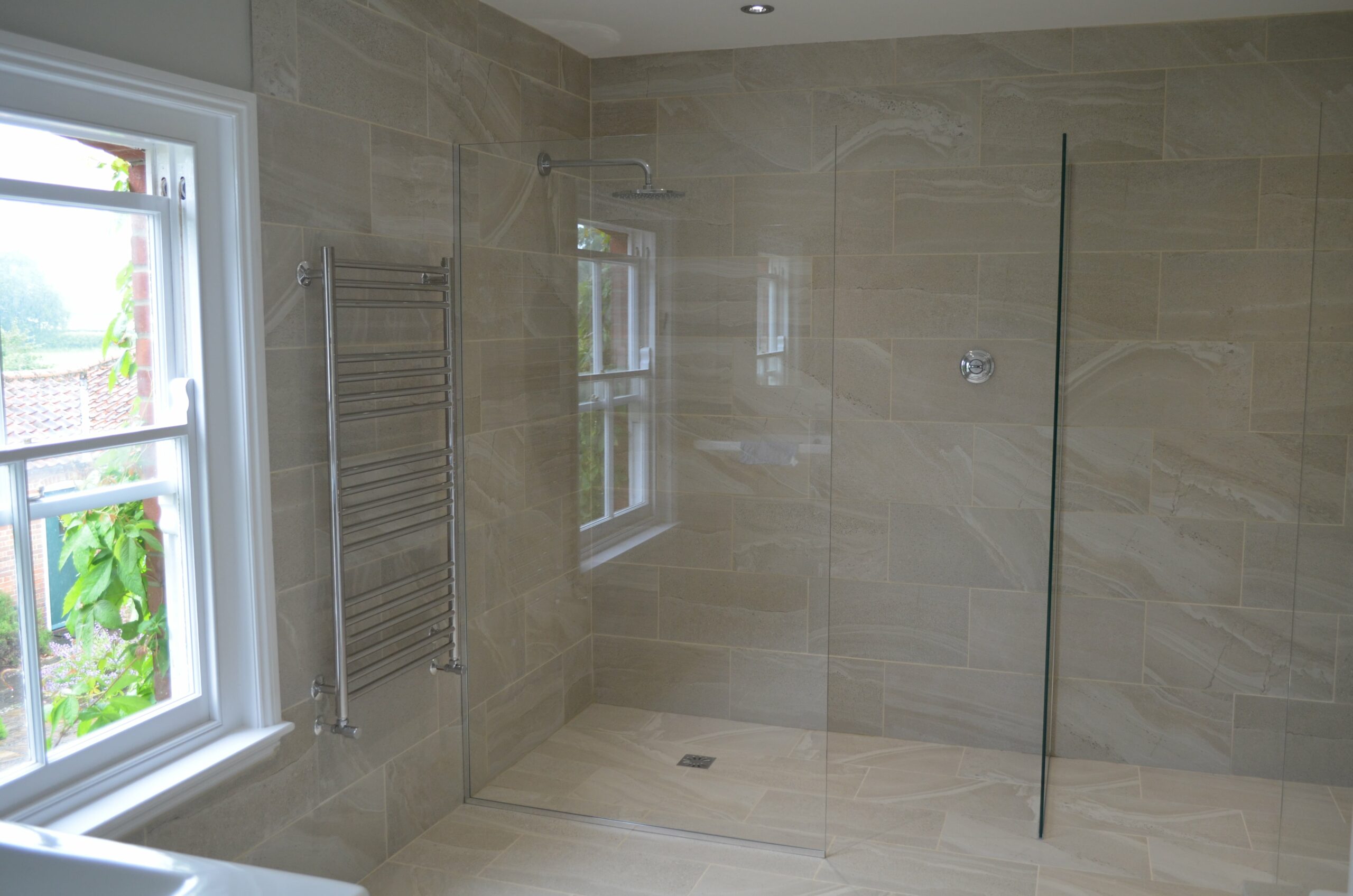 glass walk in shower in neutral bathroom