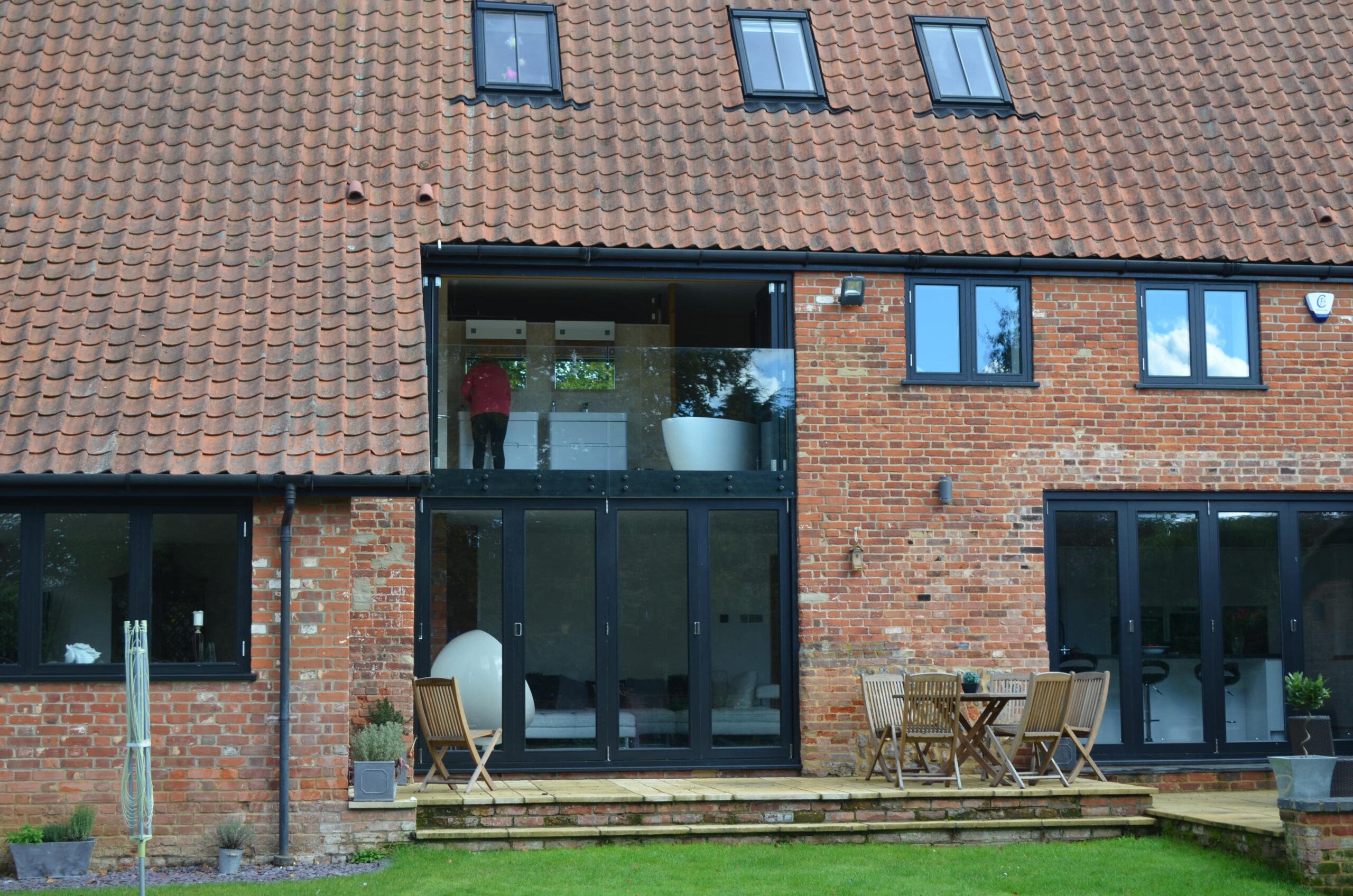 old barn conversion with built in balcony and glass panelling