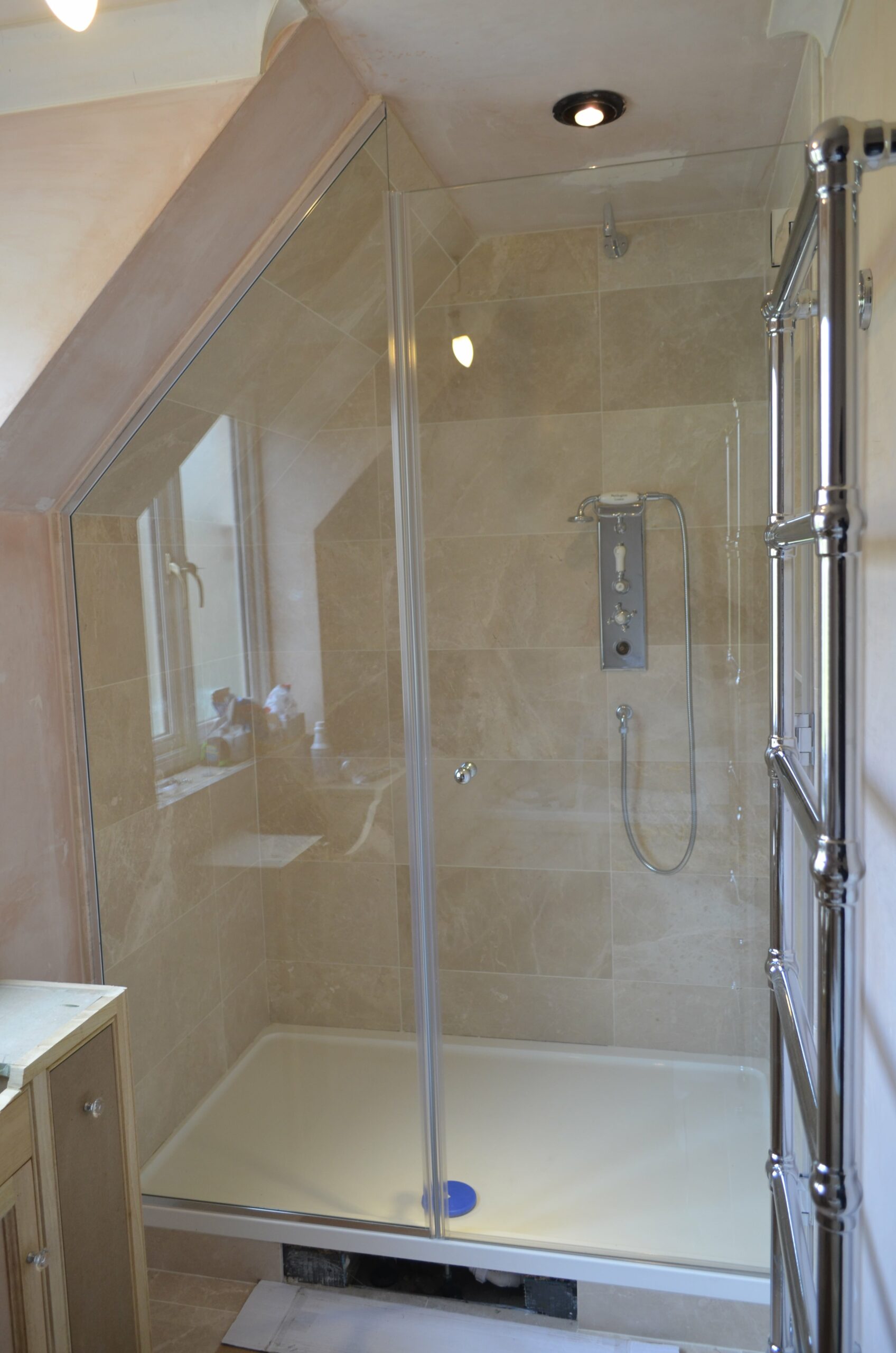asymmetrical shaped shower space with glass screen and door