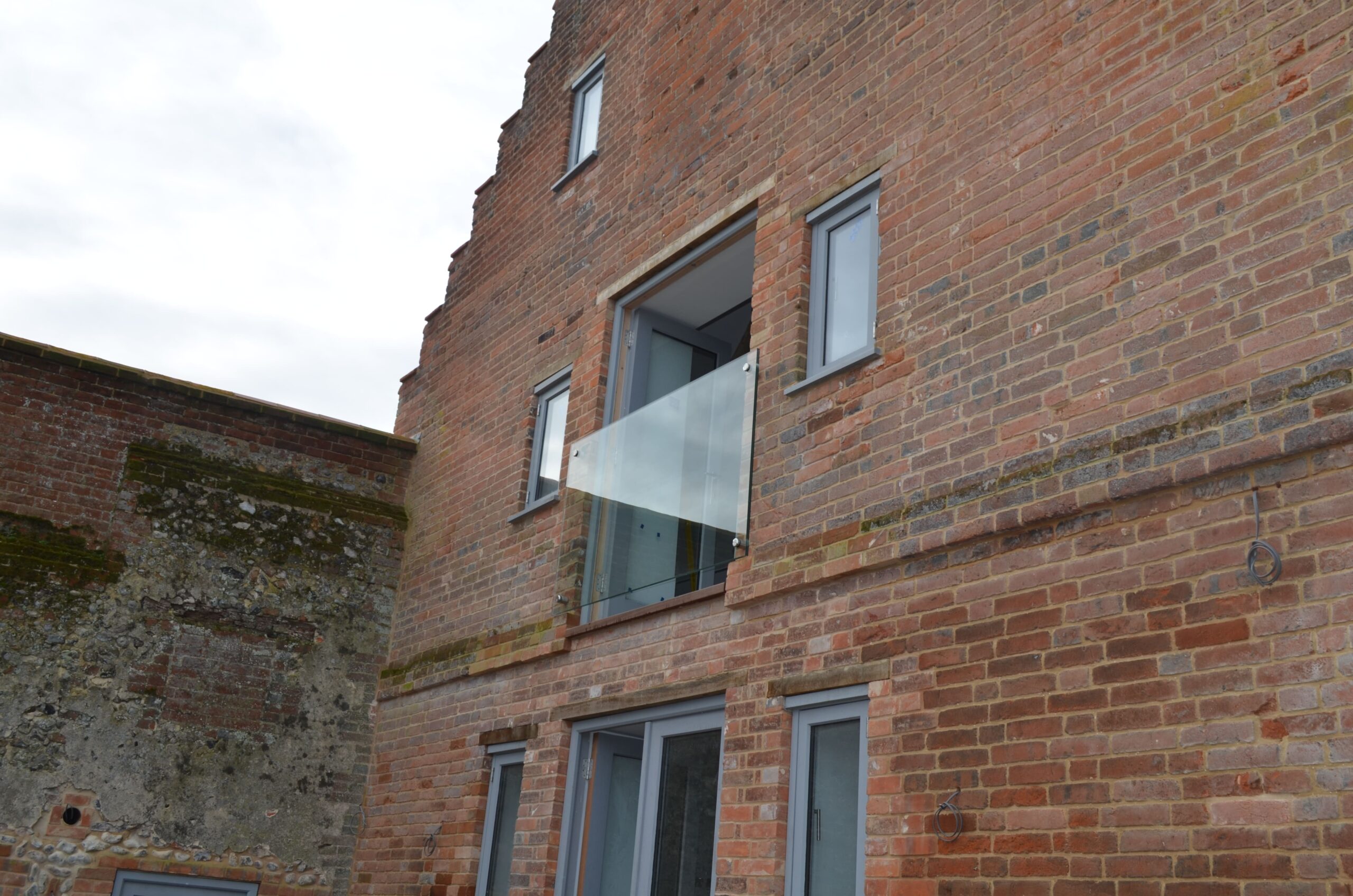 frameless modern balcony for historic norfolk property