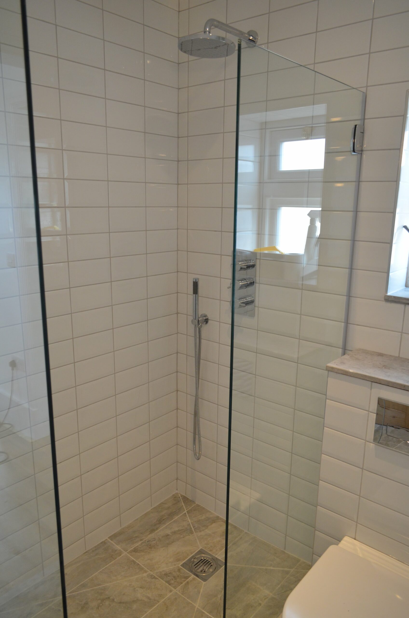 small walk in shower with glass screens