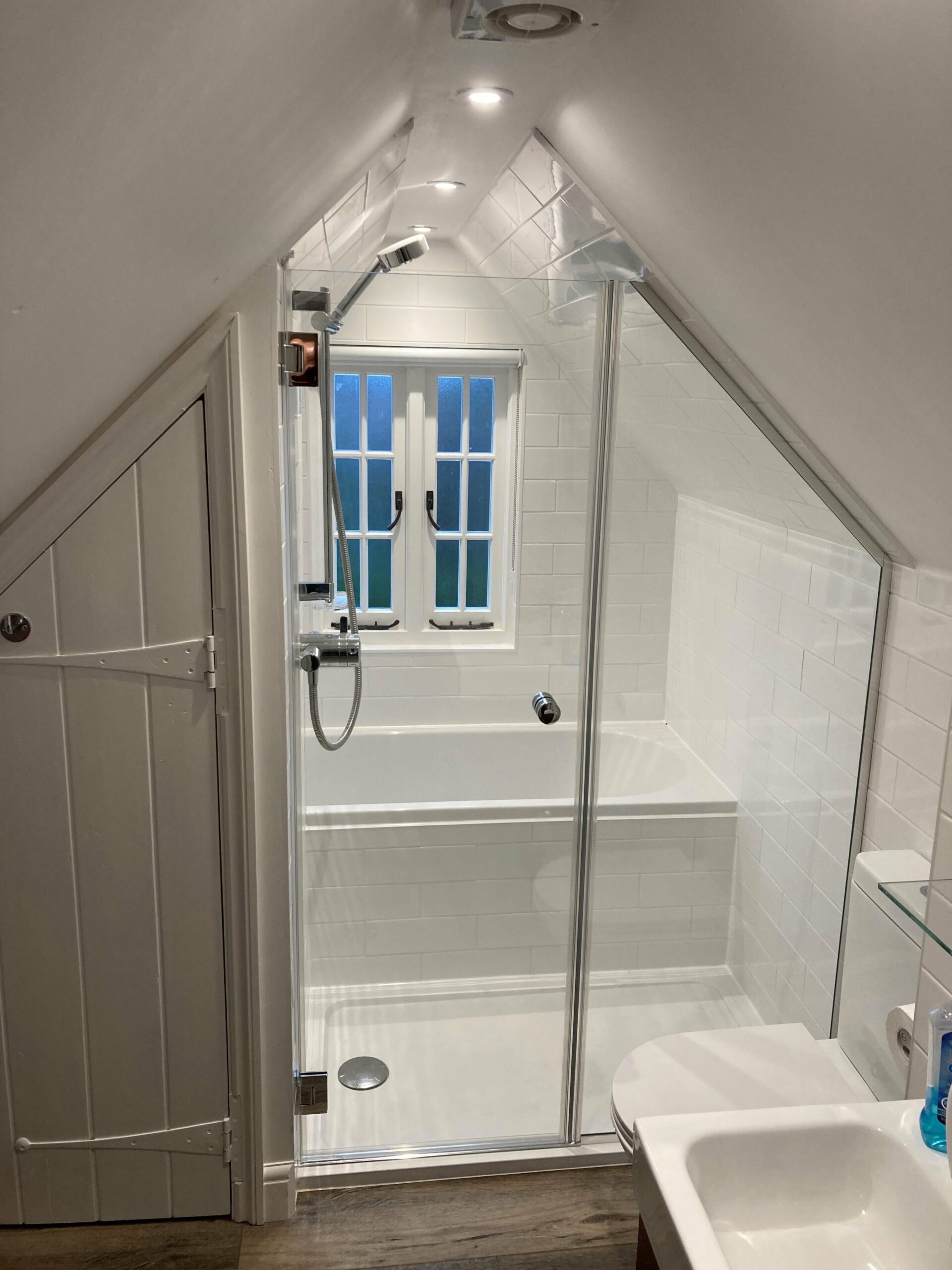triangular shaped shower space with glass screen and door
