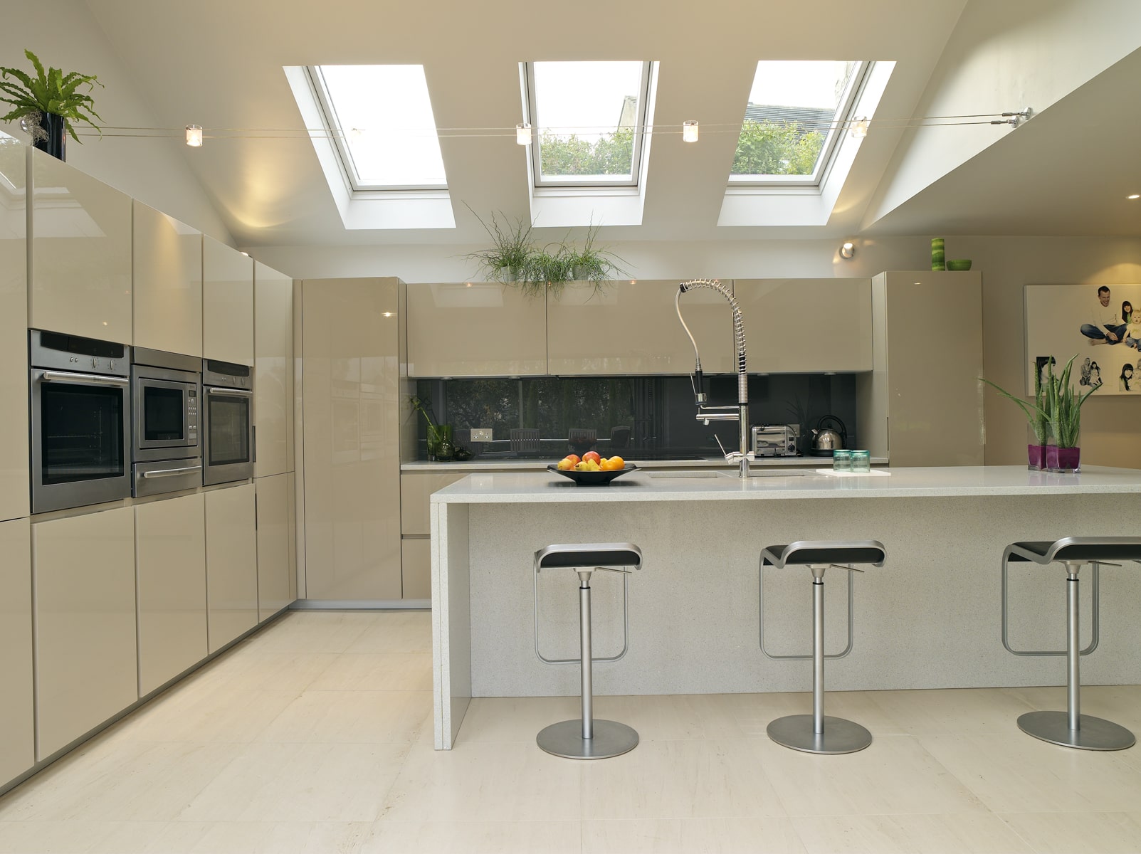 bright open kitchen dining space in cream with a charcoal splashback