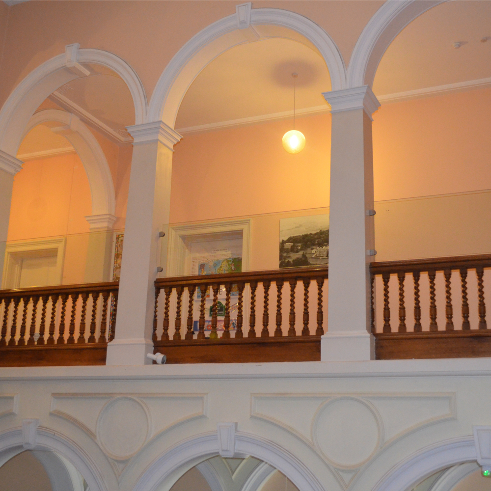 glass balustrade installed above art gallery bannister to increase safety