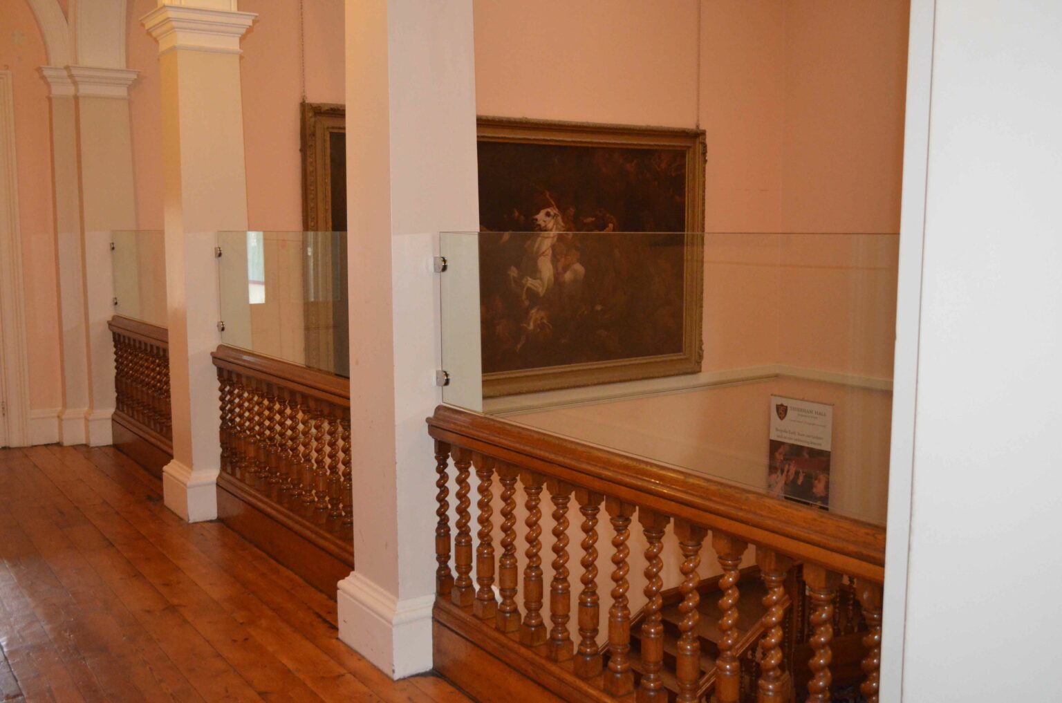 glass balustrades installed along staircase in art gallery