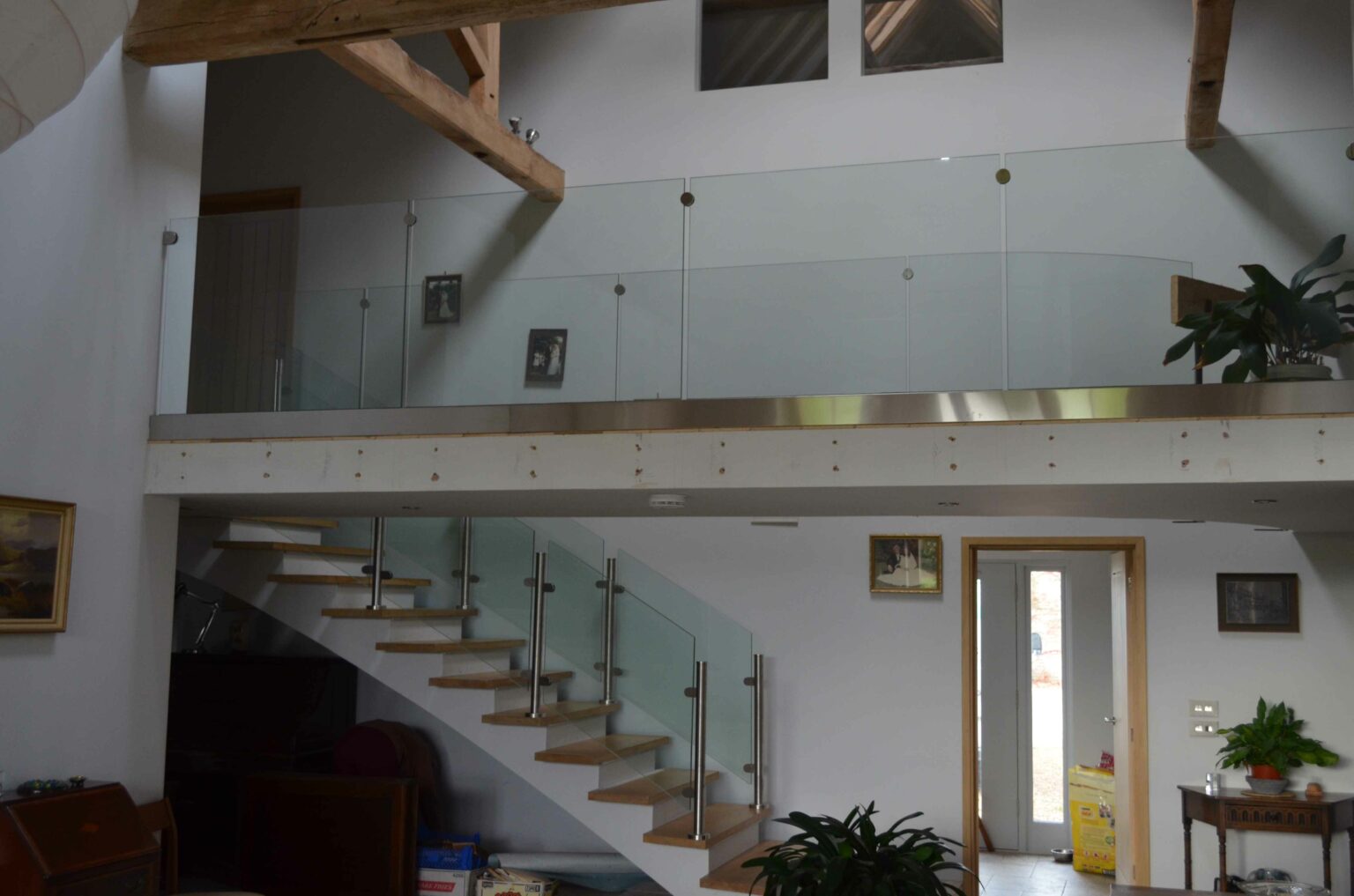 glass landing balustrade with wraparound staircase