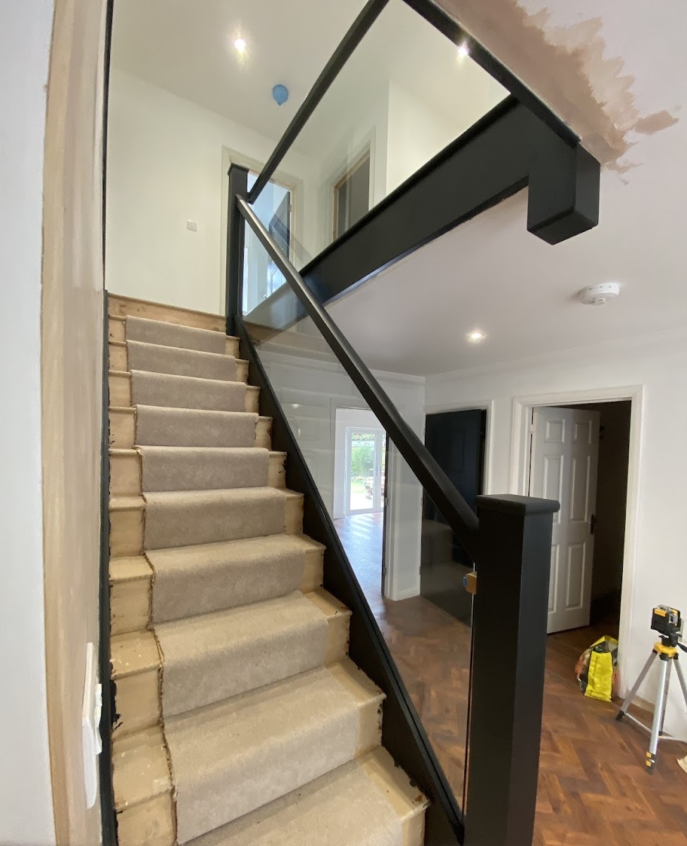 Wooden staircase with long glass balustrades