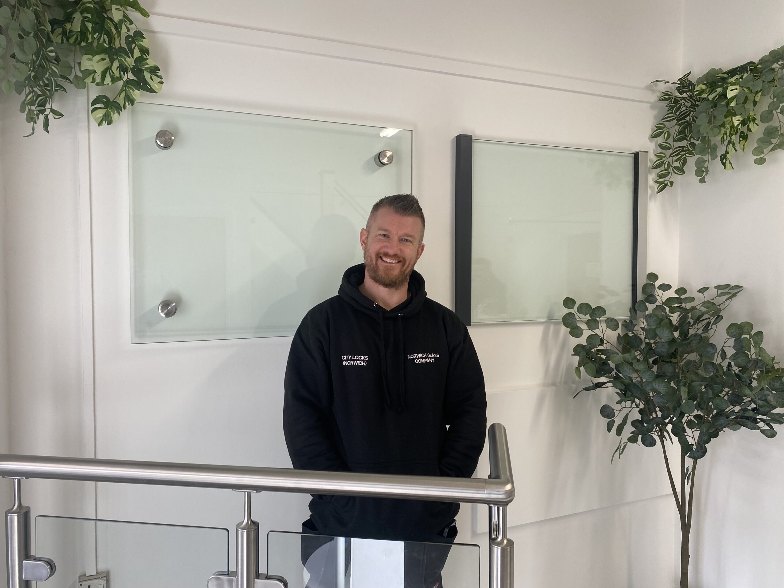 Smiling man standing on front of glass samples